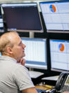 Employees checking screen in the processing plant