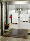 Employees loading boxes of salmon into a truck