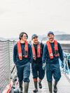 Three employees walking on gangway