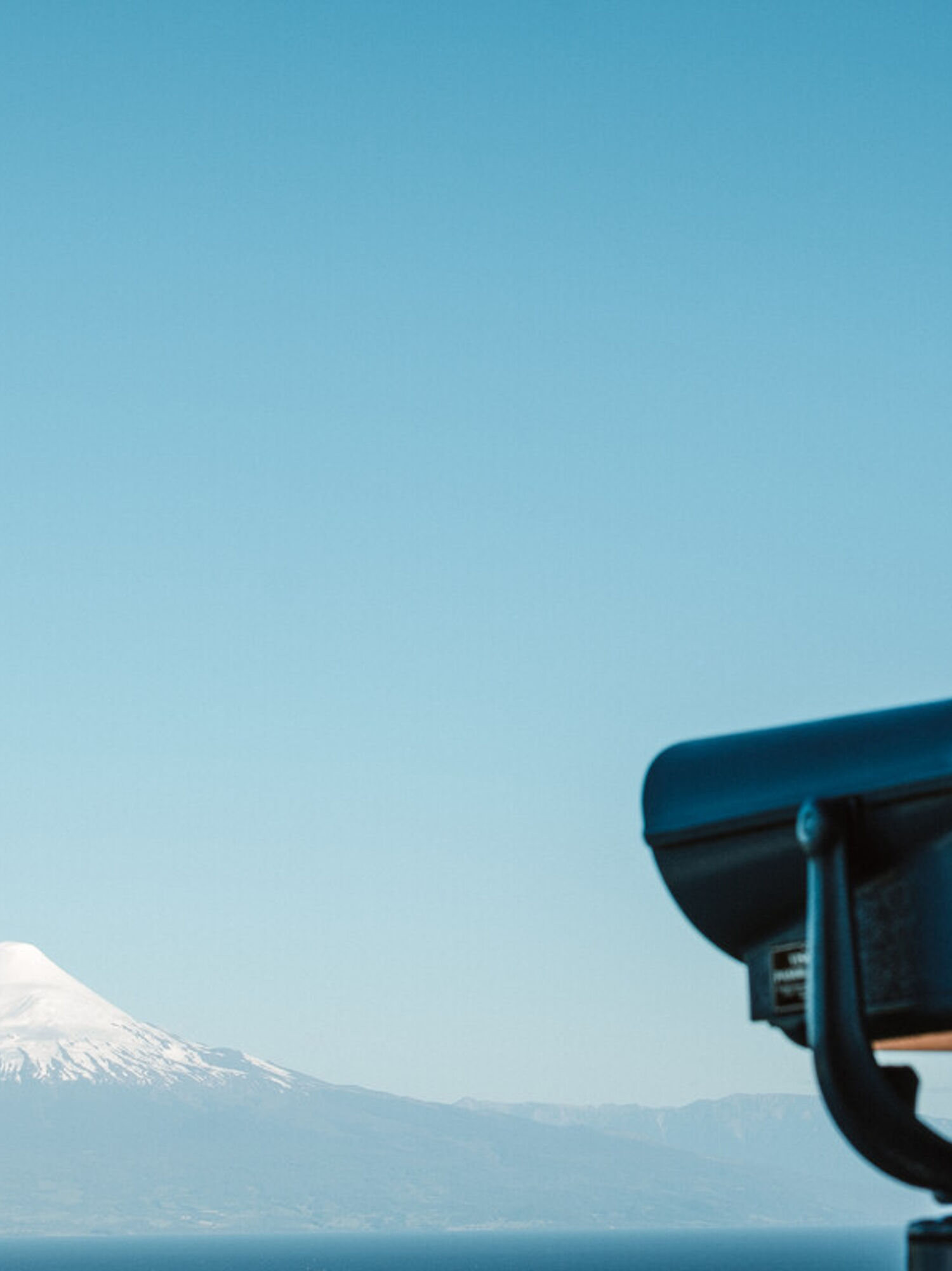 Spotlight pointing towards a volcano in the distance
