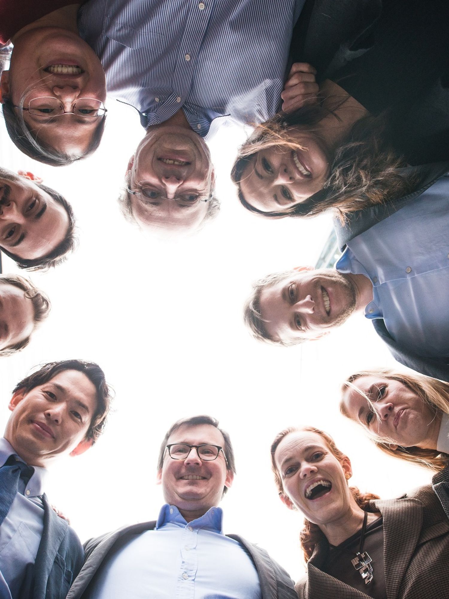 A group of employees looking down at the camera