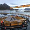 Sensorhouse being installed in one of the net pens at the sea site